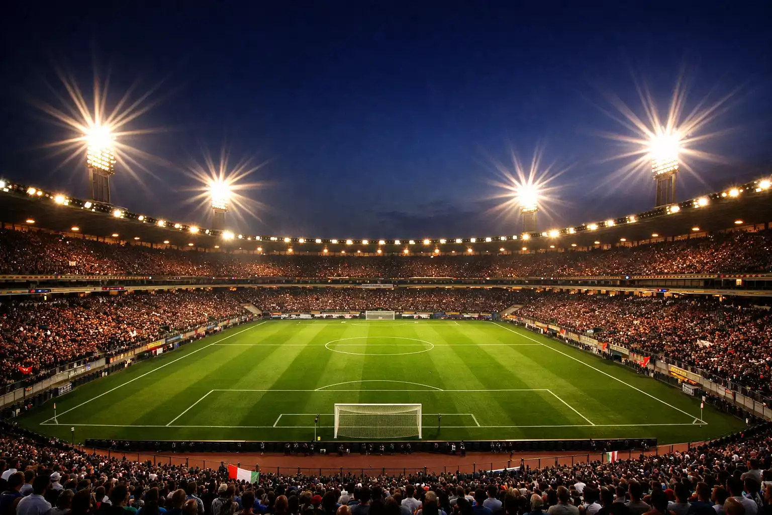 Stadio di calcio italiano illuminato durante una partita serale